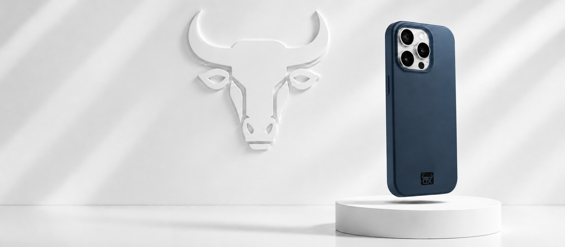 A dark blue protective phone case standing upright on a white cylindrical pedestal, with a white bull head wall sculpture in the background.